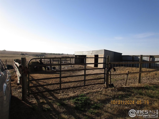 13969 County Road 33, Sterling, CO 80751 - view of gate featuring an exterior structure, an outbuilding, and a rural view