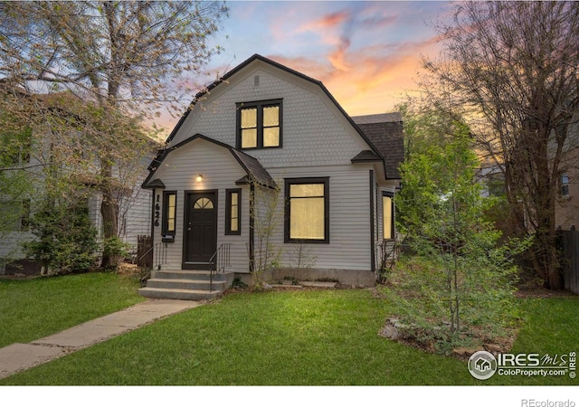 1626 11th Ave, Greeley, CO 80631 - colonial inspired home featuring a gambrel roof, a yard, and roof with shingles