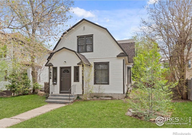 1626 11th Ave, Greeley, CO 80631 - dutch colonial with a gambrel roof, a front yard, and a shingled roof
