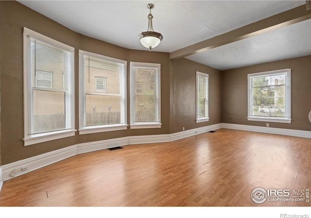1626 11th Ave, Greeley, CO 80631 - unfurnished room featuring wood finished floors, baseboards, and beamed ceiling