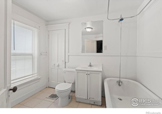 1626 11th Ave, Greeley, CO 80631 - bathroom featuring a freestanding bath, tile patterned flooring, toilet, and vanity