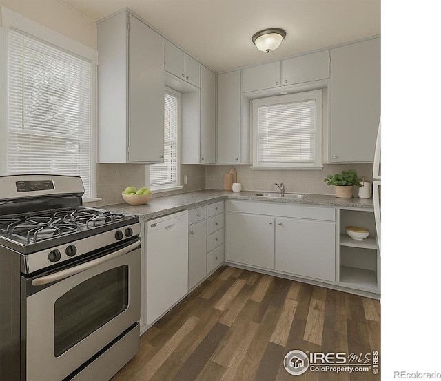 1626 11th Ave, Greeley, CO 80631 - kitchen featuring stainless steel range with gas stovetop, white dishwasher, light countertops, a sink, and white cabinetry