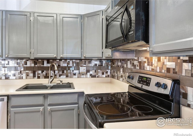 kitchen featuring gray cabinetry, appliances with stainless steel finishes, and a sink