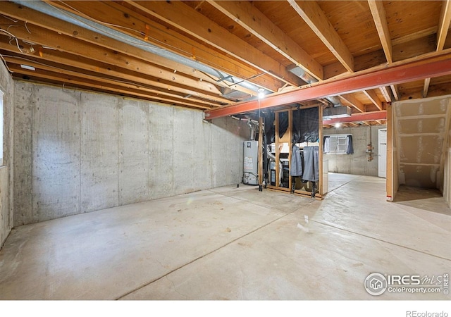 unfinished basement featuring water heater