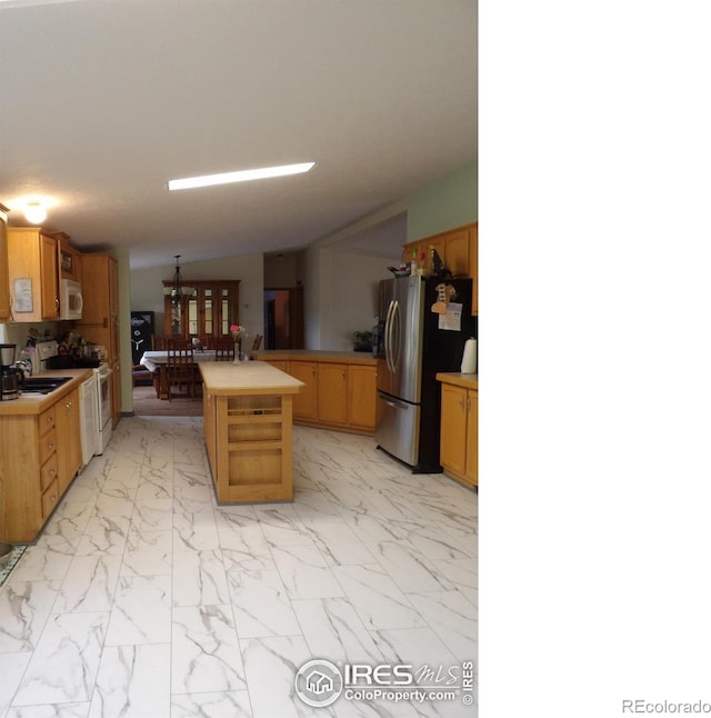9021 County Road U.5, Weldona, CO 80653 - kitchen with white appliances, light marble finish floors, light countertops, a sink, and a peninsula