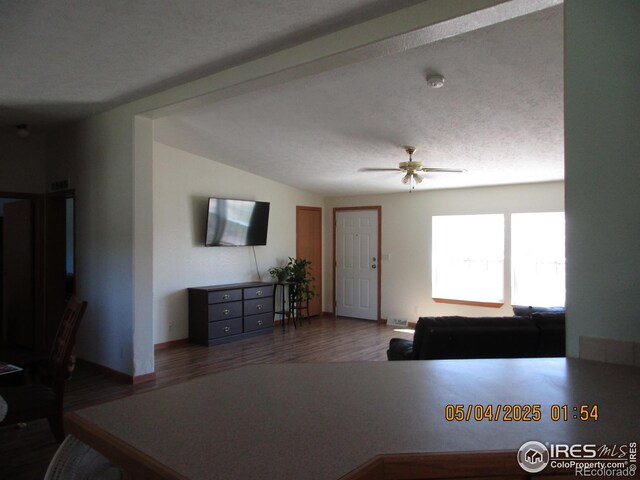 9021 County Road U.5, Weldona, CO 80653 - living area with ceiling fan, wood finished floors, and baseboards