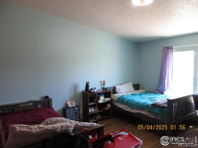 9021 County Road U.5, Weldona, CO 80653 - bedroom featuring wood finished floors and a textured ceiling