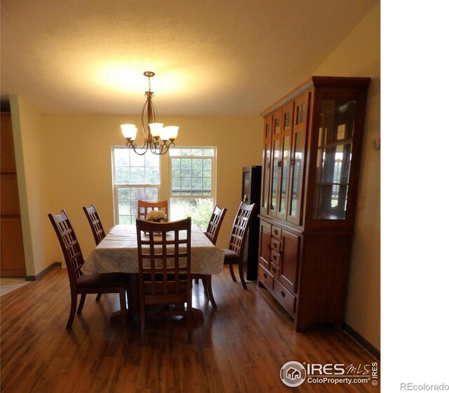 9021 County Road U.5, Weldona, CO 80653 - dining room featuring a chandelier and dark wood-style floors