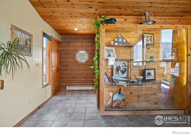 interior space with wood ceiling, baseboards, rustic walls, and baseboard heating