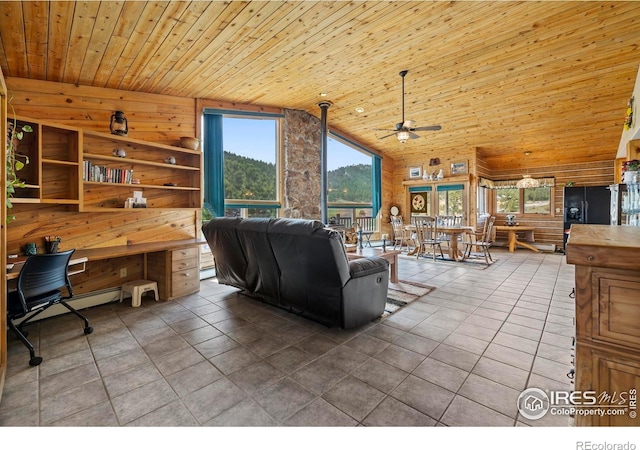 tiled living room featuring a ceiling fan, wood walls, wooden ceiling, and plenty of natural light