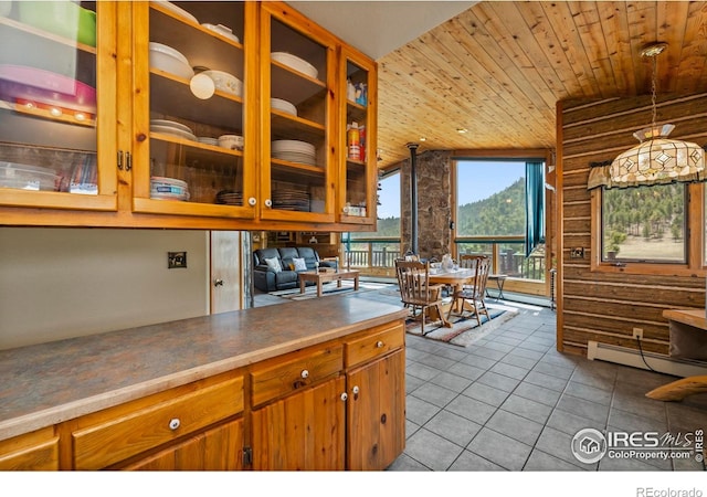 kitchen featuring wood ceiling, glass insert cabinets, brown cabinets, tile patterned floors, and baseboard heating