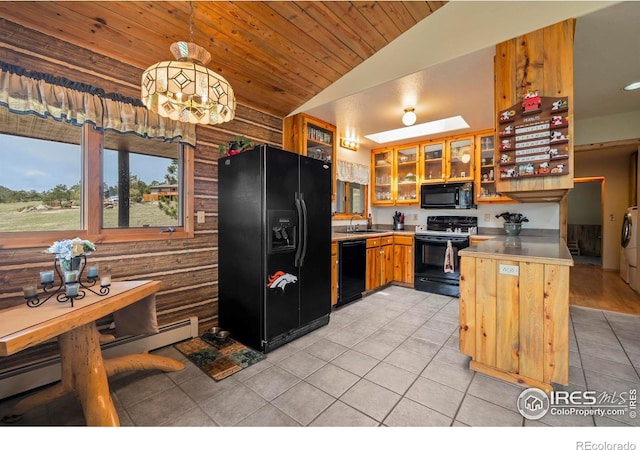 kitchen featuring a sink, black appliances, washer and dryer, light tile patterned floors, and wood ceiling
