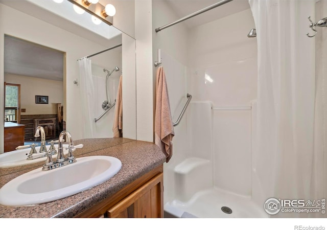 full bath featuring vanity and curtained shower