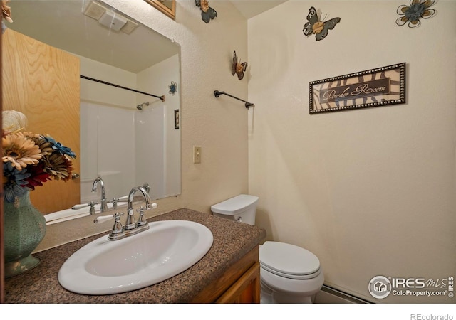 bathroom featuring toilet, visible vents, and vanity