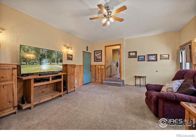 carpeted living area with ceiling fan
