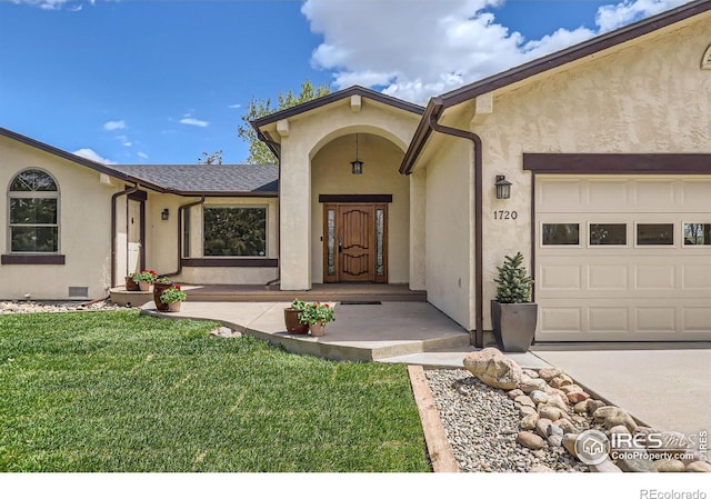 1720 Chaparro Cir, Berthoud, CO 80513 - view of exterior entry with an attached garage, stucco siding, and a lawn