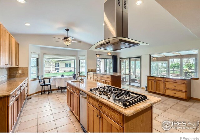 1720 Chaparro Cir, Berthoud, CO 80513 - kitchen featuring a sink, island exhaust hood, stainless steel gas stovetop, vaulted ceiling, and light tile patterned floors