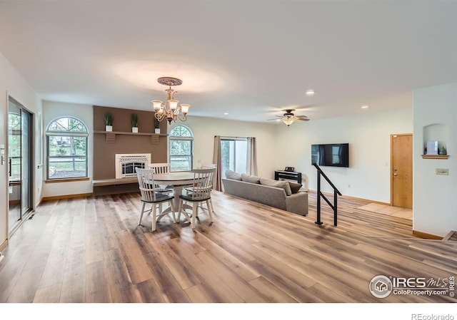 1720 Chaparro Cir, Berthoud, CO 80513 - dining room with wood finished floors, a healthy amount of sunlight, and a glass covered fireplace