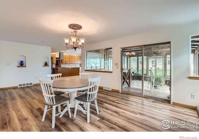 1720 Chaparro Cir, Berthoud, CO 80513 - dining space featuring baseboards, an inviting chandelier, visible vents, and wood finished floors