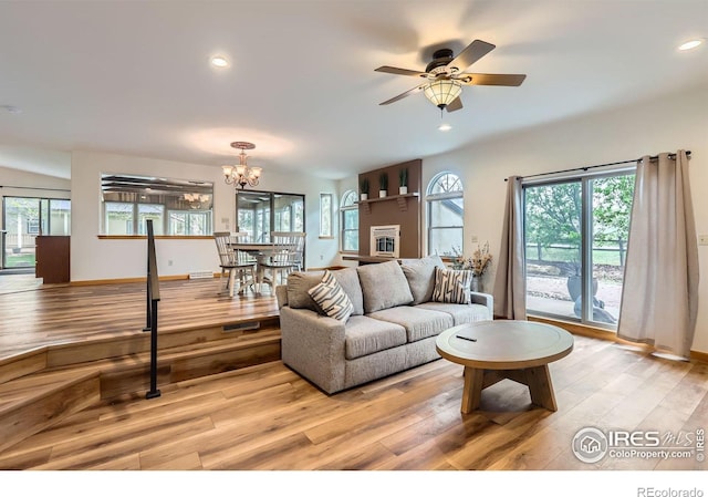 1720 Chaparro Cir, Berthoud, CO 80513 - living area with ceiling fan with notable chandelier, light wood-type flooring, a healthy amount of sunlight, and recessed lighting