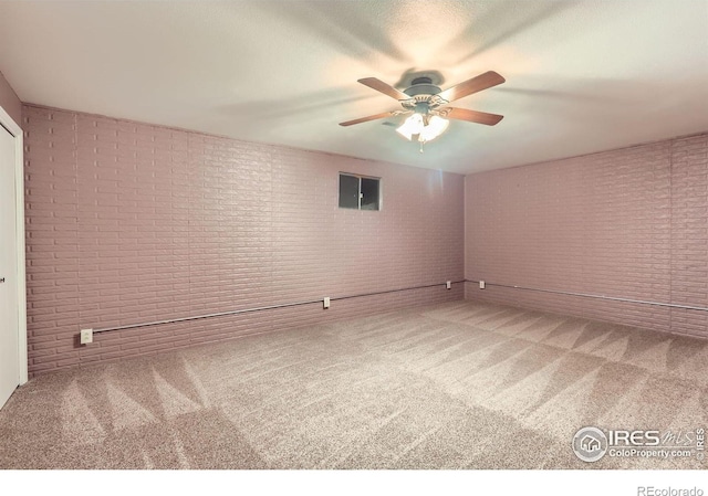 1720 Chaparro Cir, Berthoud, CO 80513 - empty room featuring carpet, a ceiling fan, and brick wall