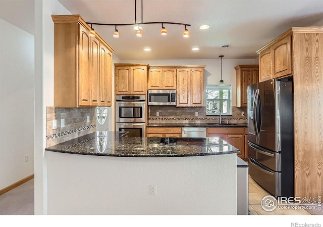 1720 Chaparro Cir, Berthoud, CO 80513 - kitchen with a sink, a peninsula, stainless steel appliances, tasteful backsplash, and dark stone counters