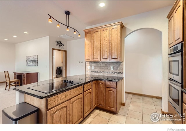 1720 Chaparro Cir, Berthoud, CO 80513 - kitchen featuring visible vents, a peninsula, backsplash, black electric cooktop, and double oven