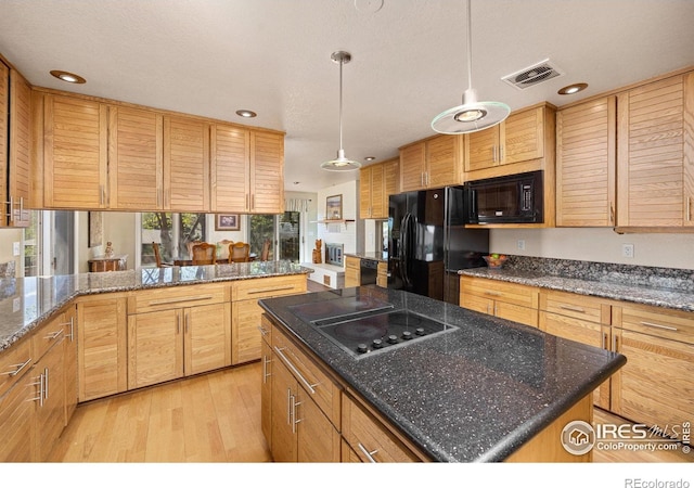 kitchen featuring black appliances, recessed lighting, light wood-style flooring, and visible vents