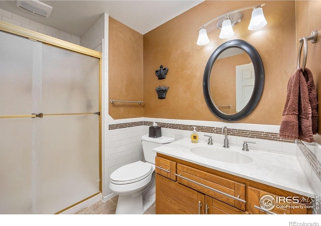 bathroom featuring toilet, vanity, visible vents, tile patterned floors, and a stall shower