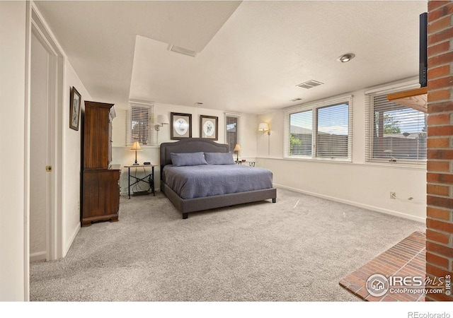 bedroom with baseboards, carpet flooring, and visible vents