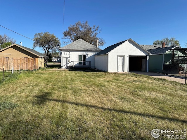 109 E 5th St, Julesburg, CO 80737 - exterior space with fence, stucco siding, and a lawn