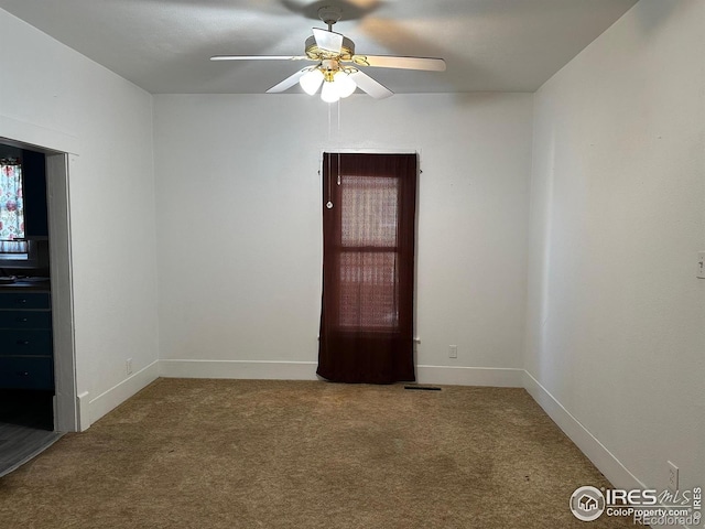 109 E 5th St, Julesburg, CO 80737 - empty room with carpet floors, a ceiling fan, and baseboards