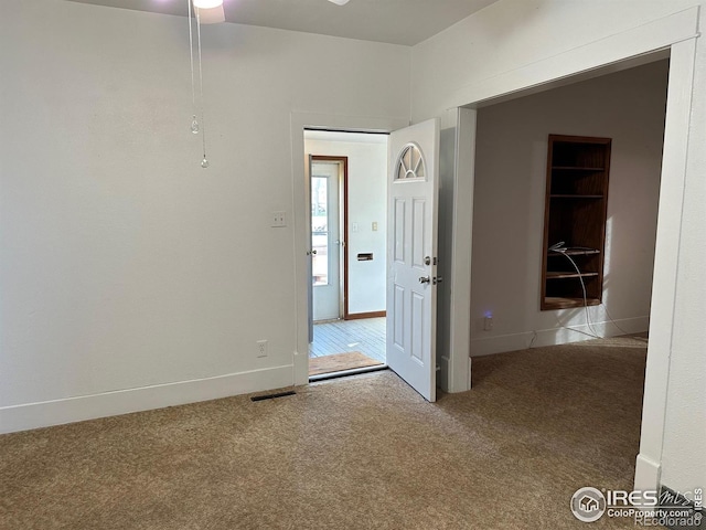 109 E 5th St, Julesburg, CO 80737 - spare room with baseboards, carpet floors, a ceiling fan, and visible vents
