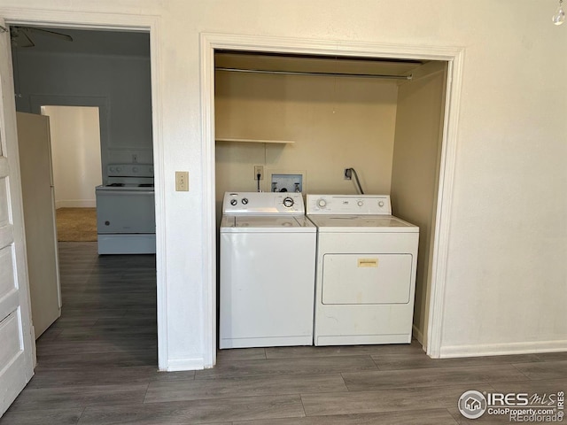 109 E 5th St, Julesburg, CO 80737 - clothes washing area featuring baseboards, laundry area, dark wood-style floors, and washer and clothes dryer