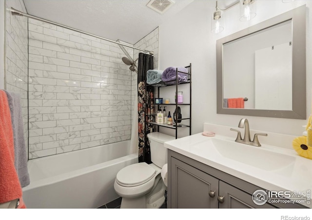 bathroom featuring vanity, toilet, visible vents, and shower / bath combo