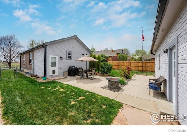 view of patio / terrace with grilling area, a fire pit, and a fenced backyard