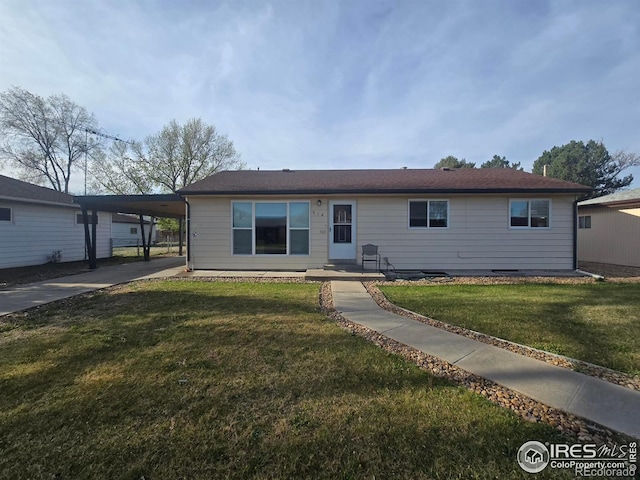 single story home featuring driveway, a front yard, and an attached carport