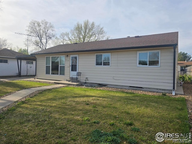 rear view of house featuring a lawn