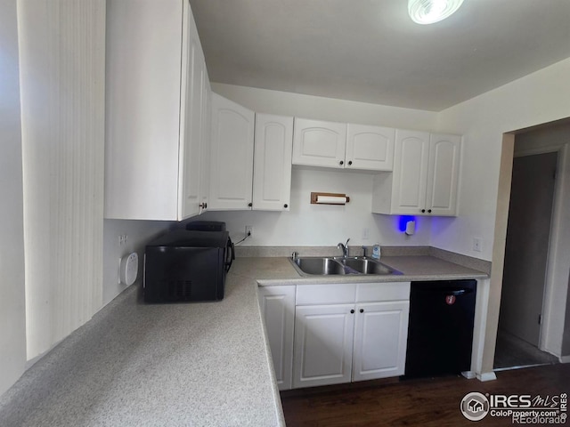 kitchen featuring a sink, white cabinetry, light countertops, and black appliances