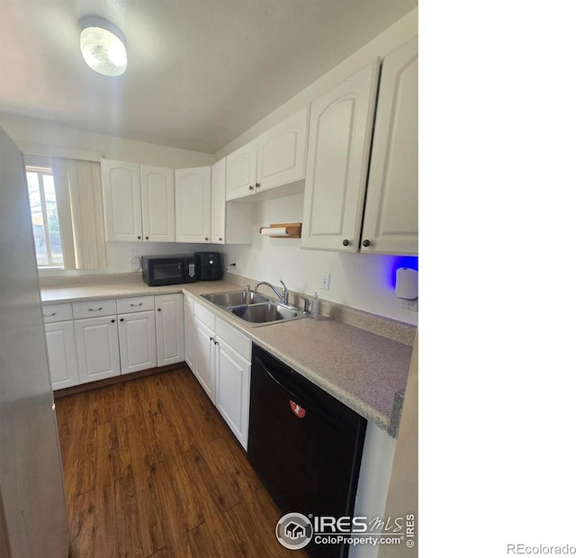 kitchen with a sink, white cabinetry, black appliances, and dark wood finished floors