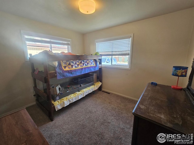 bedroom with baseboards and carpet floors