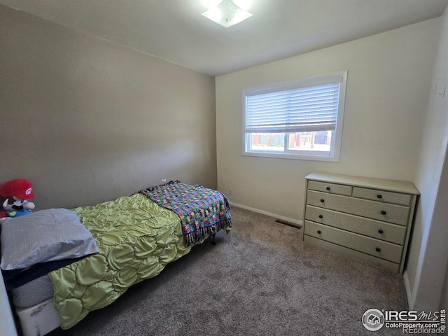 bedroom with baseboards and carpet