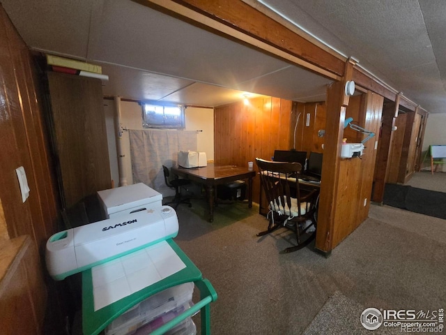 below grade area featuring carpet and wood walls