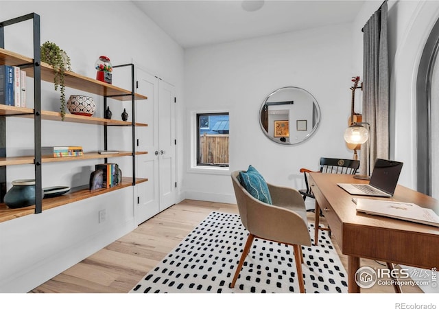 home office featuring baseboards and light wood-style flooring