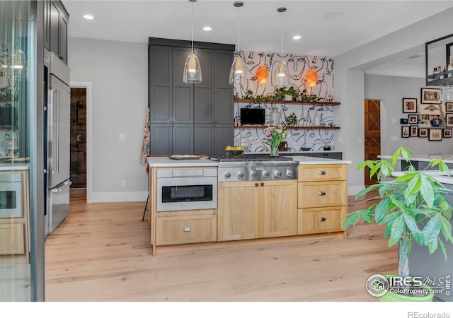 bar with stainless steel gas stovetop, light wood-type flooring, recessed lighting, baseboards, and built in fridge