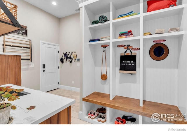 mudroom with light tile patterned floors and recessed lighting