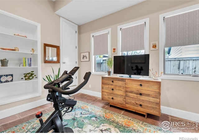 exercise room with baseboards