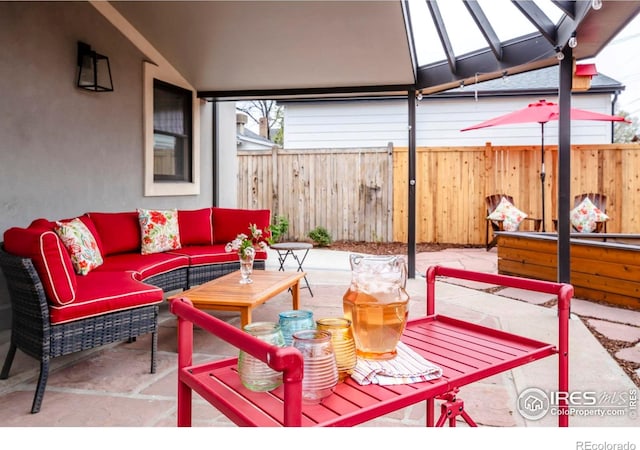 view of patio featuring an outdoor hangout area and fence