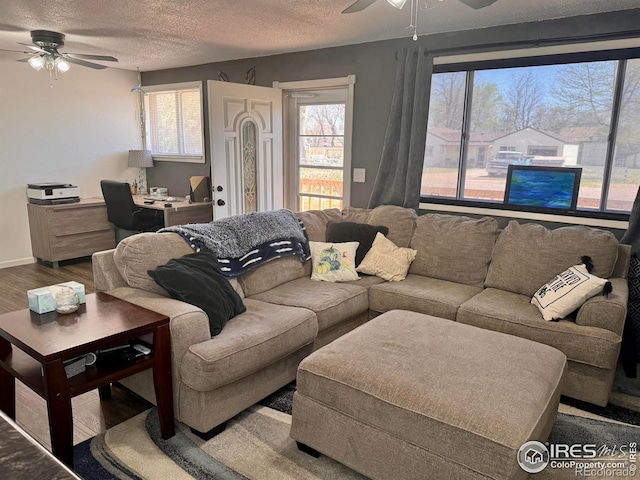 618 Melody Ln, Sterling, CO 80751 - living room with baseboards, ceiling fan, a textured ceiling, and wood finished floors