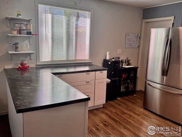 618 Melody Ln, Sterling, CO 80751 - kitchen with freestanding refrigerator, open shelves, dark wood-type flooring, white cabinets, and dark countertops